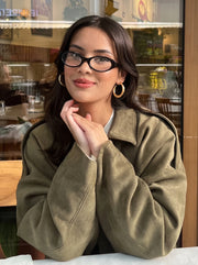 The Cropped Bomber — Olive, seated café view
